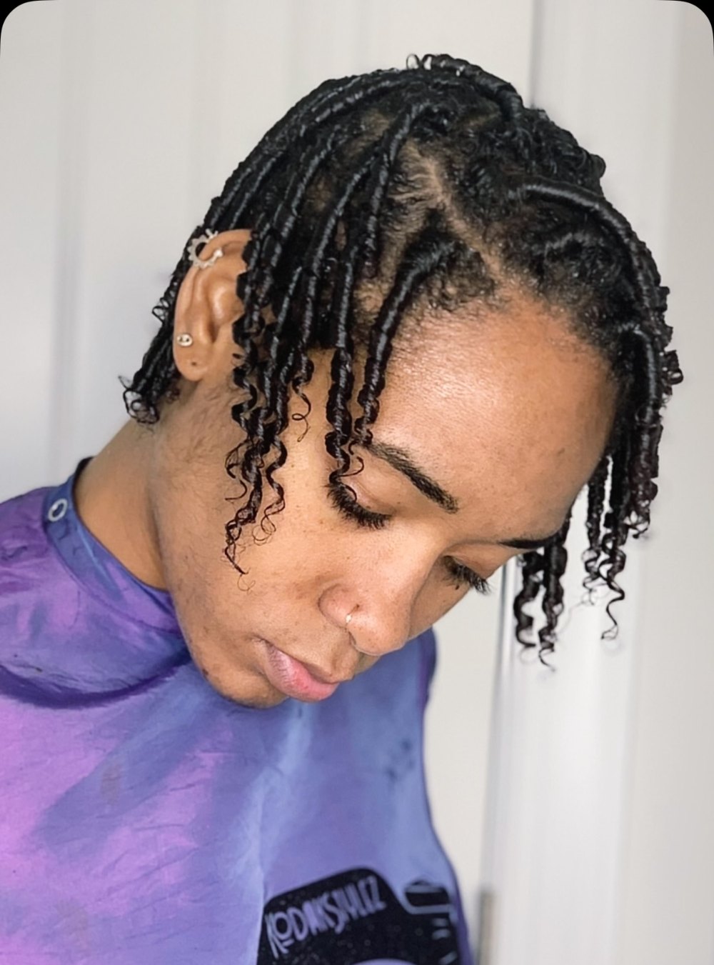 Finger coils: short natural hair set in defined coils with a side part at KodakStylez in Smyrna, GA