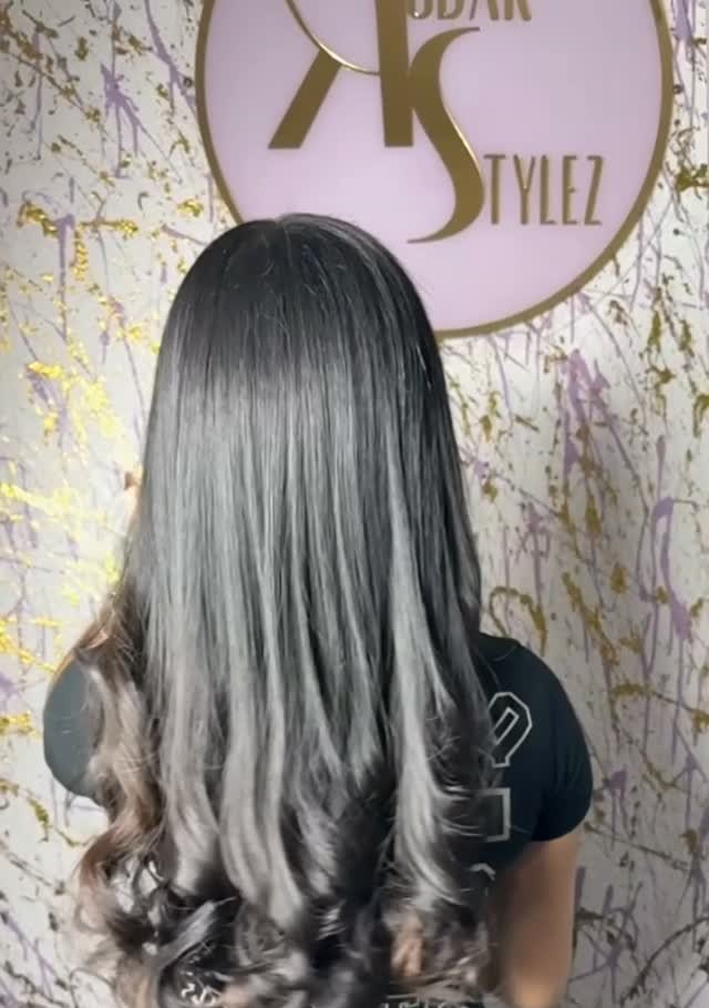 Back view of a long silk press with curled ends in front of the KodakStylez sign