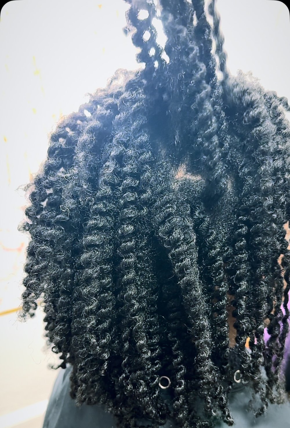 Back view of a full, defined twist out on natural hair